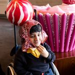 Young person trying on cupcake costume gloves during The Witches schools touch tour