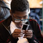 Young person inspecting liquid during The Witches schools touch tour