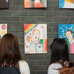 People looking at artwork on a wall