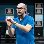 The director James Blakey in a blue polo shirt and glasses during rehearsals for The Doncastrian Chalk Circle.