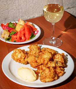 Cauliflower fritti with aioli, with a glass of natural wine.