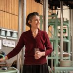 Harriet Walter smiles while filling up a glass of water.