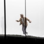 Janet McTeer, wearing a beige jacket and grey trousers is rrunning up a slope in a white-out environment