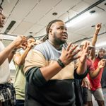 Kyle Ramar Freeman leading the cast in a scene, in rehearsals for A Strange Loop.