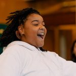 Monique Walker, wearing a white hoodie, rehearsing Hamlet for younger audiences.