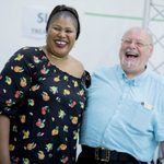 Two people smiling during rehearsal.