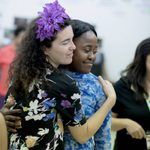 Two people in rehearsal, embracing one another.