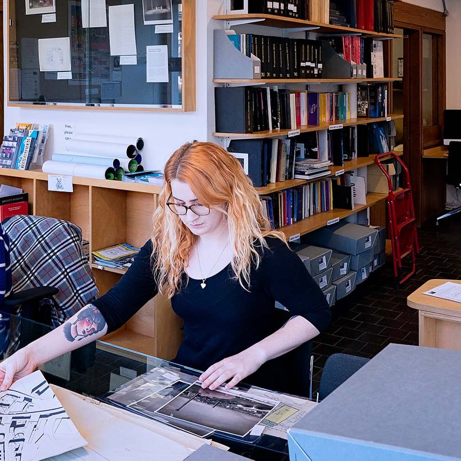 A picture of the Archive research room, people sifting through archive material and others sat at a computer with headphones