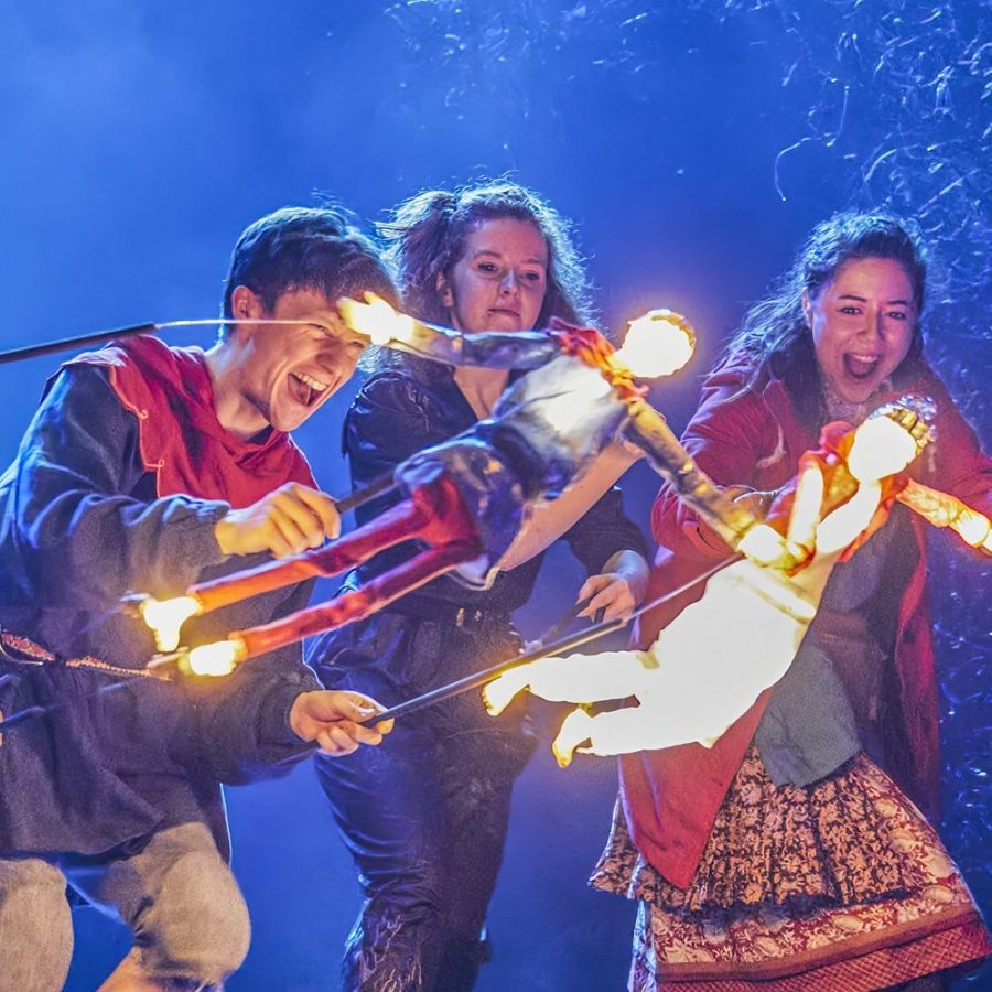 Domonic Ramsden and Keir Oglivy (Boy), operating two illuminated stick puppets, as Aimee McGolderick and Millie Hikasa (Lettie) look on, laughing