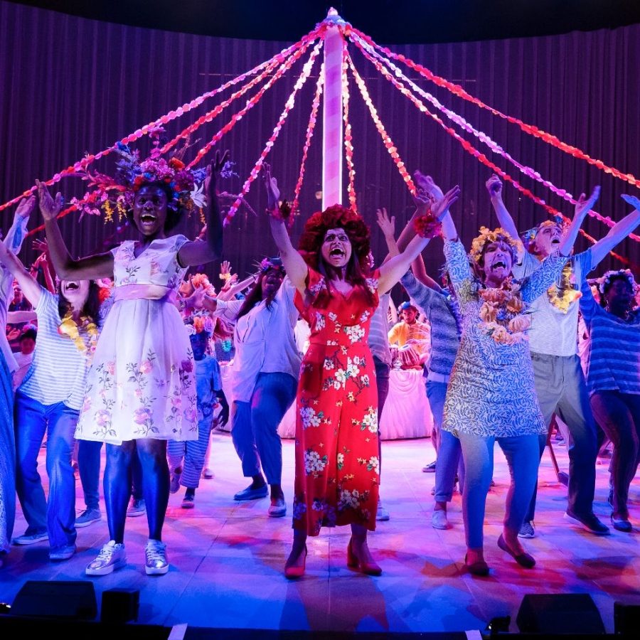 Ayesha Dharker as Simonida with cast, surrounding a Maypole, in Pericles