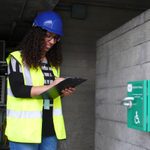 Apprentice in hard hat with clipboard