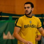 Simeon Desvignes, wearing a yellow and black Brasil t-shirt, and another cast member rehearsing Hamlet for younger audiences.