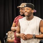 Tendai Humphrey Sitima and Yeukayi Ushe, standing, smiling, in rehearsals for A Strange Loop.