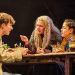 Keir Ogilvy (Boy), Finty Williams (Old Mrs Hempstock) and Millie Hikasa (Lettie) sitting around an old wooden table, deep in conversation